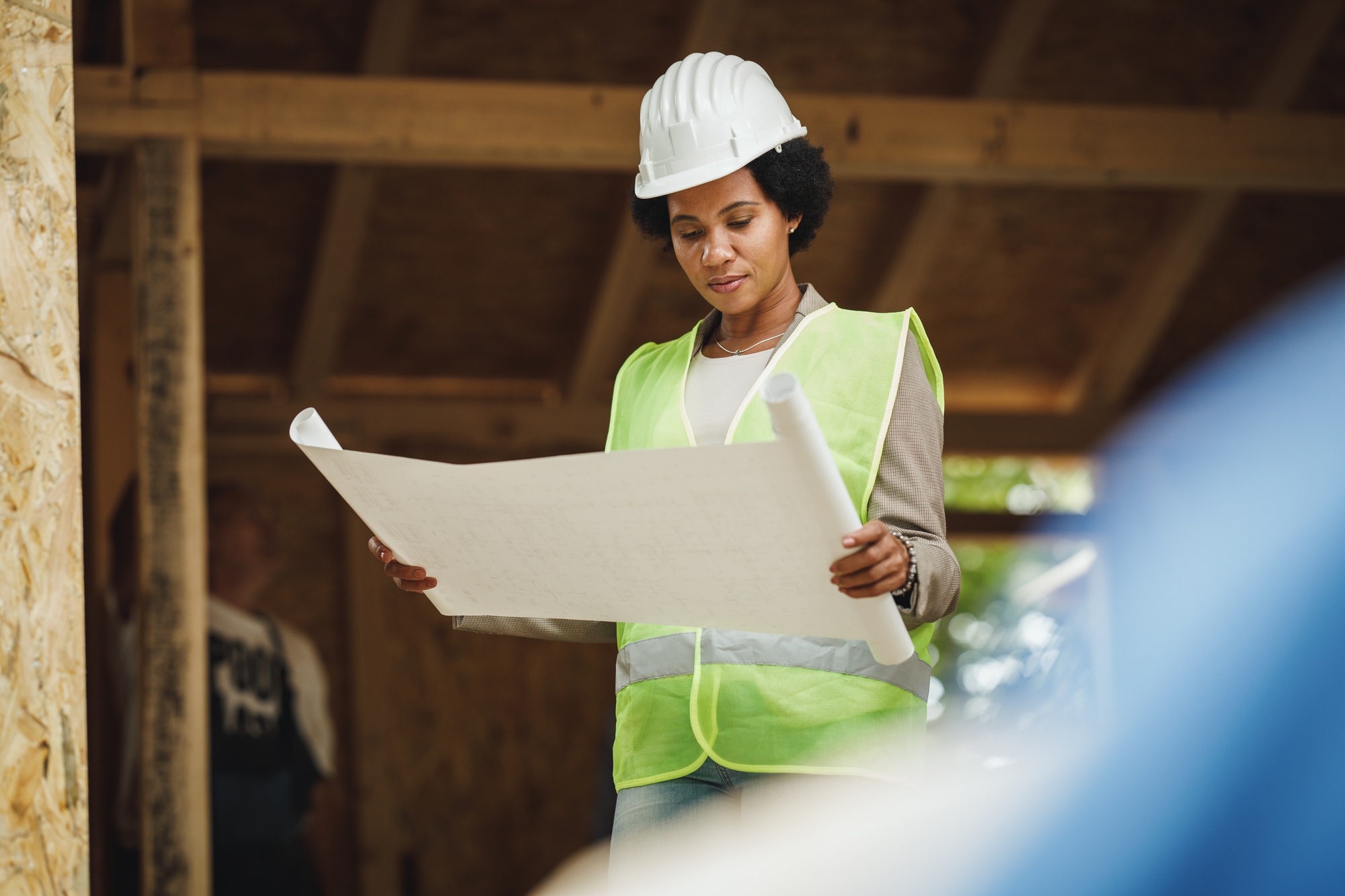 Construction Worker on Site with Plans